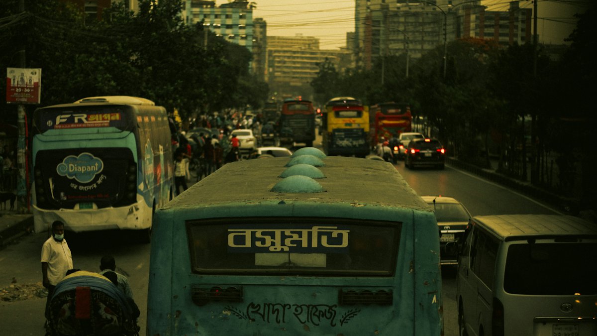 A busy Dhaka street filled with traffic